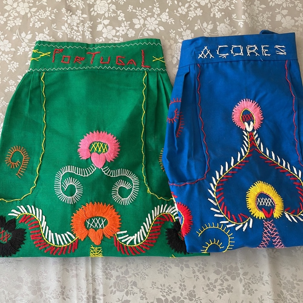 Two hand-embroidered, handmade half aprons, from Portugal.